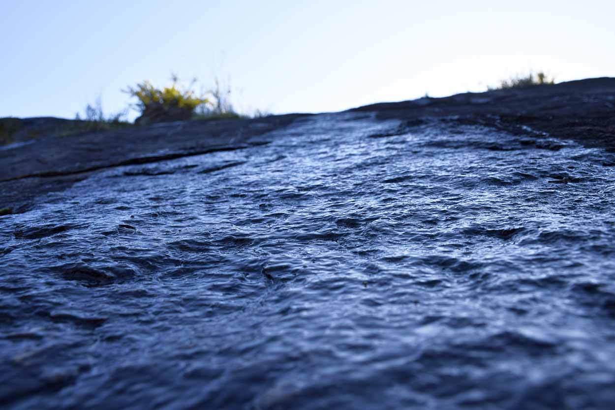 Water trickles over the rocks near Jane Brook, Eagle View Walk Trail, John Forrest National Park, Perth, Western Australia